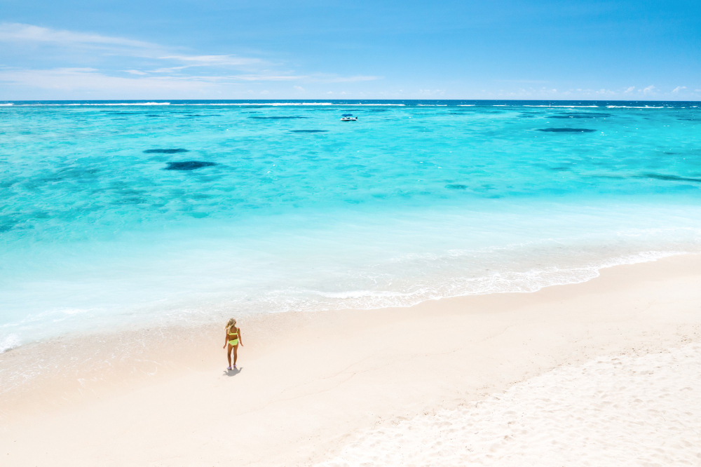 woman on the shores of long bay beach